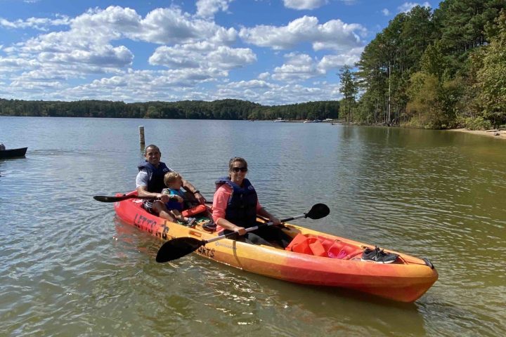 a group of people in a small boat in a body of water